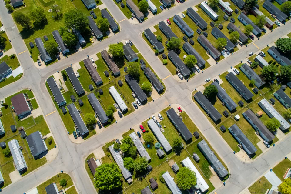 Aerial view of manufactured homes on green lawn.